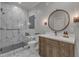 Bright bathroom features a glass shower with marble tiling, a wooden vanity, and a modern mirror at 116 Palermo Ct, Apex, NC 27539