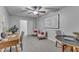 Charming sitting room with grey walls, plush carpet, and modern ceiling fan fixture at 116 Palermo Ct, Apex, NC 27539
