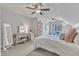 Bright primary bedroom featuring carpeted floors, multiple ceiling fans, and built-in vanity at 116 Palermo Ct, Apex, NC 27539