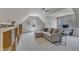Spacious bonus room featuring plush seating, a ceiling fan, and natural light, ideal for a Gathering room or playroom at 116 Palermo Ct, Apex, NC 27539