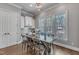 Bright dining area with large windows, a wooden table with chairs, and access to a patio or deck at 116 Palermo Ct, Apex, NC 27539