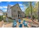 Rear exterior view with a fire pit and multiple outdoor seating areas surrounded by lush landscaping at 116 Palermo Ct, Apex, NC 27539