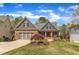 Charming home with a two-car garage, inviting front porch, and a beautifully landscaped front yard at 116 Palermo Ct, Apex, NC 27539