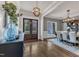 Grand foyer leading to a dining room, features hardwood floors and striking lighting fixtures creating an inviting space at 116 Palermo Ct, Apex, NC 27539
