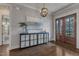 Elegant foyer with hardwood floors, stylish console table, artwork, and decorative lighting creating a welcoming entrance at 116 Palermo Ct, Apex, NC 27539