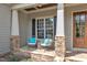 Inviting front porch featuring stone pillars, comfortable seating, and a view of the landscaped front yard at 116 Palermo Ct, Apex, NC 27539
