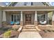 Inviting front porch featuring stone pillars, stylish seating, and a double-door entryway, perfect for relaxing at 116 Palermo Ct, Apex, NC 27539