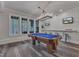 Game room with a pool table, bar seating, ample natural light, and stylish pendant lighting at 116 Palermo Ct, Apex, NC 27539