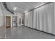 Finished garage has ample space, a large stainless fridge, stairs to upper levels, and doors to the yard at 116 Palermo Ct, Apex, NC 27539