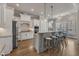 Bright, open kitchen with white cabinets, granite countertops, stainless steel appliances, and bar seating at 116 Palermo Ct, Apex, NC 27539