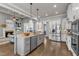 Modern kitchen with stainless steel appliances, granite countertops, and an open view to the living room with fireplace at 116 Palermo Ct, Apex, NC 27539