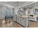 Open-concept kitchen features an island, stainless steel appliances, and adjoins a dining area and a cozy living space at 116 Palermo Ct, Apex, NC 27539