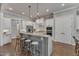 Well-lit kitchen features white cabinetry, stainless steel appliances, a center island, and hardwood floors at 116 Palermo Ct, Apex, NC 27539