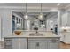 Kitchen island featuring granite countertops and modern pendant lights overlooking a cozy living area at 116 Palermo Ct, Apex, NC 27539