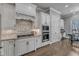Kitchen with white cabinets, granite countertops, stainless steel appliances, and a decorative tile backsplash at 116 Palermo Ct, Apex, NC 27539