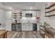 Stylish kitchenette featuring modern appliances, white cabinets, open shelving, and wood-look flooring at 116 Palermo Ct, Apex, NC 27539