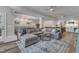 Spacious living room with a large sectional sofa, area rug, and an open layout perfect for entertaining at 116 Palermo Ct, Apex, NC 27539