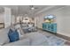 Open living space with a sectional sofa, kitchenette, entertainment center, and stylish flooring at 116 Palermo Ct, Apex, NC 27539