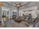 Bright living room boasts high ceilings, a ceiling fan, ample seating, and seamless flow to kitchen area at 116 Palermo Ct, Apex, NC 27539