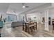 Open living space showcasing a sectional sofa, kitchenette, entertainment area, and ample natural light at 116 Palermo Ct, Apex, NC 27539