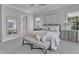Comfortable main bedroom with a decorative bench seat, accent furniture, and a view of the outdoors at 116 Palermo Ct, Apex, NC 27539