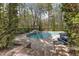 Backyard pool with stone patio and perimeter landscaping provides a relaxing outdoor space at 116 Palermo Ct, Apex, NC 27539