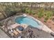 Aerial view of backyard pool area features ample seating and natural rock waterfall feature at 116 Palermo Ct, Apex, NC 27539
