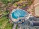 Private swimming pool with rock features, sun loungers, and a cozy outdoor seating area for ultimate relaxation at 116 Palermo Ct, Apex, NC 27539