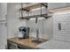 Close-up of a wet bar featuring a modern coffee machine, stainless steel beer tap, and decorative shelves at 116 Palermo Ct, Apex, NC 27539