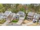 Aerial view of a two-story home showcasing its well-maintained lawn, mature trees, and neighborhood at 119 Faison Rd, Chapel Hill, NC 27517