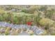 Aerial view of a suburban home near a golf course, nestled among mature trees and manicured lawns at 119 Faison Rd, Chapel Hill, NC 27517