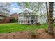 Large backyard with a spacious back porch and landscaped flower beds, perfect for entertaining at 119 Faison Rd, Chapel Hill, NC 27517