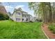Spacious backyard with lush lawn, mature trees, and outdoor recreation space, ideal for Gathering fun at 119 Faison Rd, Chapel Hill, NC 27517