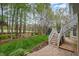 Beautiful backyard with a green lawn, mature trees, manicured landscape, and brick pavers at 119 Faison Rd, Chapel Hill, NC 27517