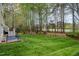 Expansive backyard featuring well-manicured lawn and mature trees, perfect for outdoor living at 119 Faison Rd, Chapel Hill, NC 27517