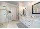 Sleek bathroom featuring double vanities, and glass-enclosed shower at 119 Faison Rd, Chapel Hill, NC 27517