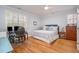 Bright bedroom features hardwood floors, a ceiling fan, and a writing desk at 119 Faison Rd, Chapel Hill, NC 27517