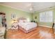Bright bedroom with hardwood floors, an overhead fan, and a window with blinds at 119 Faison Rd, Chapel Hill, NC 27517