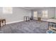 Spacious bonus room with carpet floor, two windows, and workout equipment at 119 Faison Rd, Chapel Hill, NC 27517
