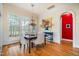 Dining room with hardwood floors, neutral walls, and large windows with a backyard view at 119 Faison Rd, Chapel Hill, NC 27517