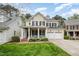 Charming two-story home with a welcoming front porch, manicured lawn, and a two-car garage at 119 Faison Rd, Chapel Hill, NC 27517