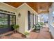 Inviting front porch with brick flooring, white columns, and cozy seating, perfect for relaxing outdoors at 119 Faison Rd, Chapel Hill, NC 27517