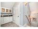 Hallway with a bar area, a door, and stairs leading up at 119 Faison Rd, Chapel Hill, NC 27517