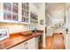 Kitchen showcasing a countertop bar with glassware, wine storage, and hardwood floors at 119 Faison Rd, Chapel Hill, NC 27517
