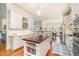 Beautiful kitchen featuring a center island, white cabinets, and an adjacent dining area at 119 Faison Rd, Chapel Hill, NC 27517