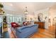Bright and airy living room featuring hardwood floors, a fireplace, and ample natural light streaming through large windows at 119 Faison Rd, Chapel Hill, NC 27517