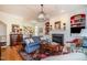 Warm living room features a fireplace, built-in shelving, and hardwood floors, creating an inviting atmosphere at 119 Faison Rd, Chapel Hill, NC 27517
