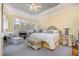 Charming main bedroom with a light yellow wall, large windows, and elegant furnishings at 119 Faison Rd, Chapel Hill, NC 27517