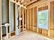 Bright bathroom under construction features wood framing and a window overlooking the outdoors at 1218 Kingwood Dr, Raleigh, NC 27609