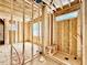 Bathroom under construction with wood framing, window, and preliminary plumbing for custom design at 1218 Kingwood Dr, Raleigh, NC 27609